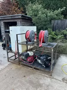Custom fabricated frame with twin diesel pressure washers and dual hose reels built for a van-mounted off-grid cleaning system in Birmingham.